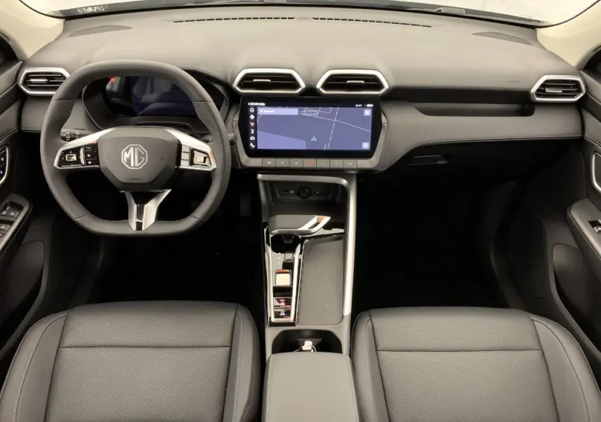 Vue intérieure frontale du tableau de bord et volant noir du MG ZS 1.5 L HYBRID+ 197 CH LUXURY avec écran tactile central.