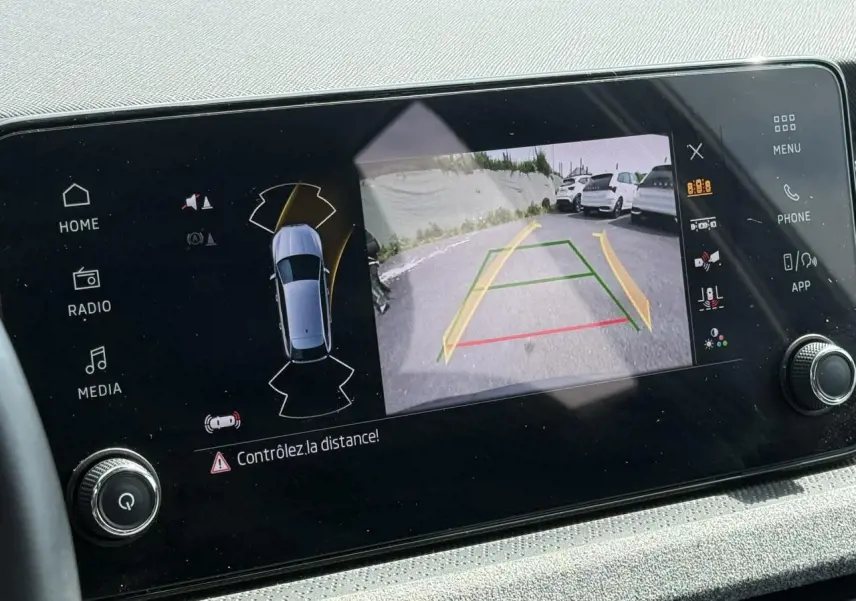 Écran central de la Skoda Scala TSI 116 gris graphite montrant la caméra de recul avec guidage dynamique.