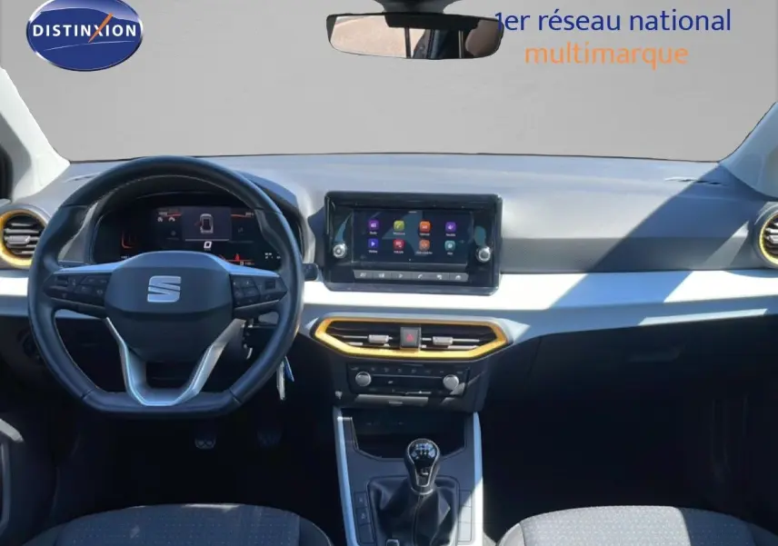 Vue intérieure frontale du tableau de bord de la SEAT Arona gris magnetic avec volant cuir et écran tactile central.