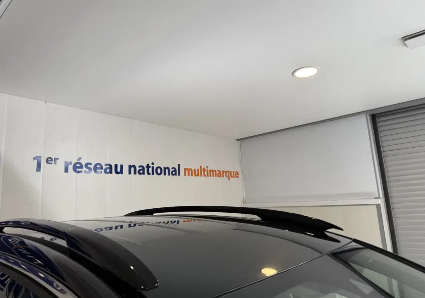 Toit noir brillant avec barres de toit noires du Citroën C5 Aircross gris Artense, vue partielle en intérieur.