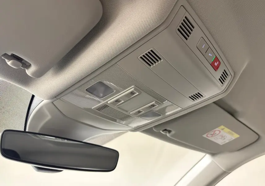 Plafonnier avec commandes d'éclairage et rétroviseur intérieur dans un Volkswagen T-Cross noir intense 2024.