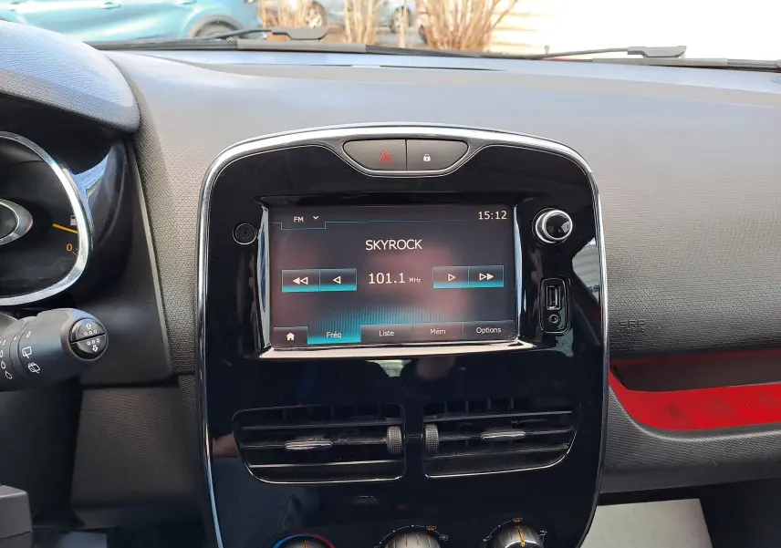 Vue rapprochée du tableau de bord noir de la Renault Clio IV avec écran tactile affichant la radio sur 101.1 MHz.