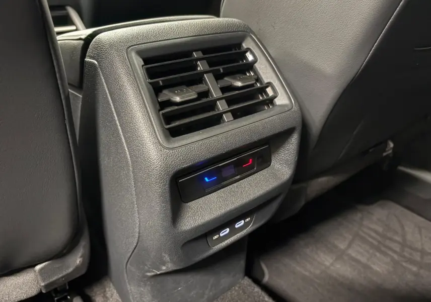 Détail des aérateurs arrière et commandes de climatisation dans l’habitacle noir du Volkswagen Tiguan Gris Dauphin 2025.