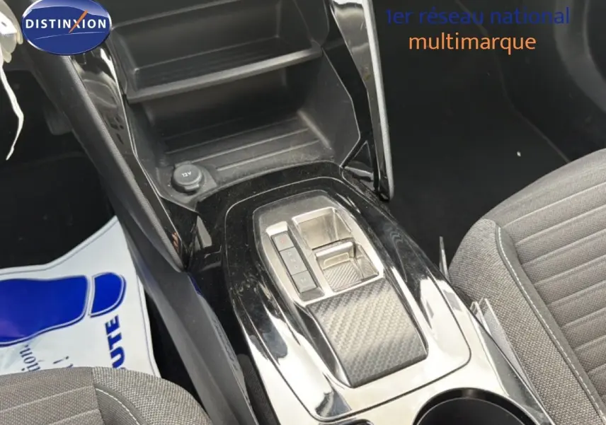 Vue rapprochée de la console centrale noire brillante avec levier de boîte automatique sur Peugeot 2008 2022.