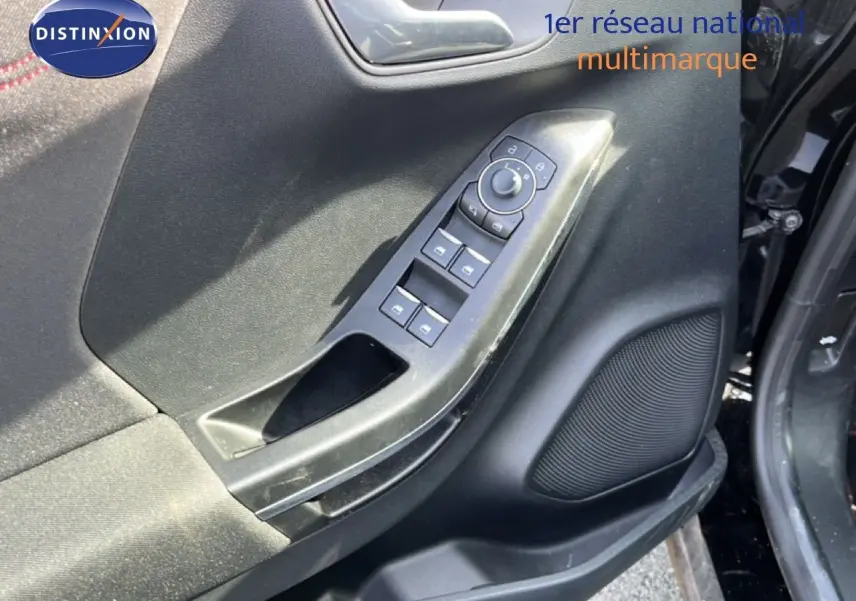 Détail de la porte côté conducteur du Ford Puma noir agate métal 2023, avec commandes de vitres et haut-parleur intégré.