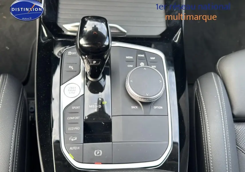 Gros plan sur la console centrale noire du BMW X3 2024 avec levier de vitesses et commandes de conduite.