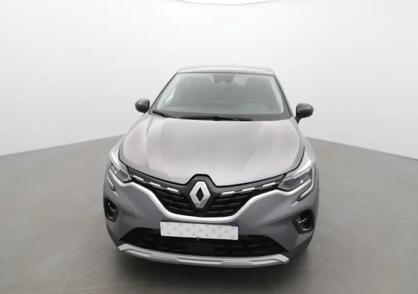 Vue avant d'un Renault Captur 2024 gris cassiope avec toit noir, mettant en valeur sa calandre distinctive et ses phares LED.