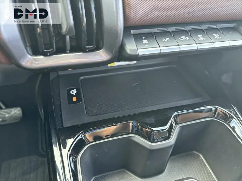 Vue rapprochée de la console centrale noire du Suzuki Vitara 2026 avec recharge sans fil et commandes climatisation.