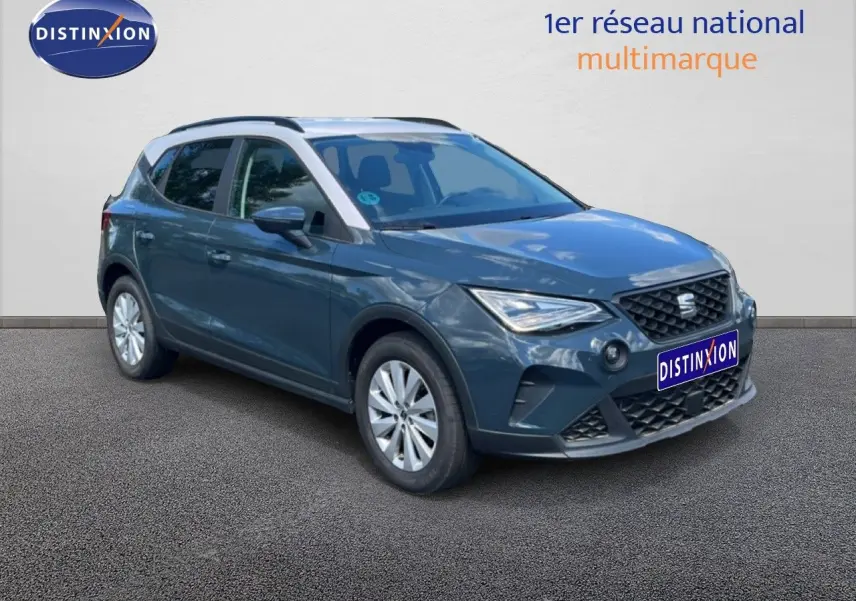 SEAT Arona bleu Fjord avec toit blanc, vue 3/4 avant droit, mettant en valeur ses lignes modernes et ses phares LED.