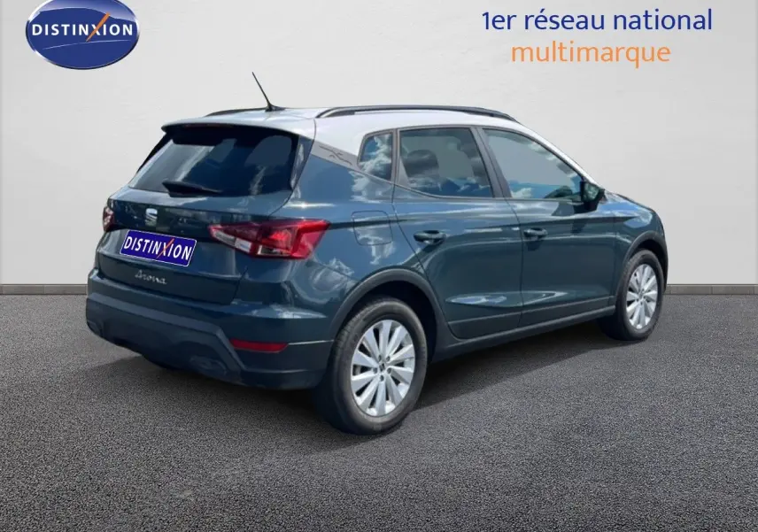 SEAT Arona bleu Fjord avec toit blanc, vue 3/4 arrière droit, mettant en valeur ses lignes compactes et modernes.