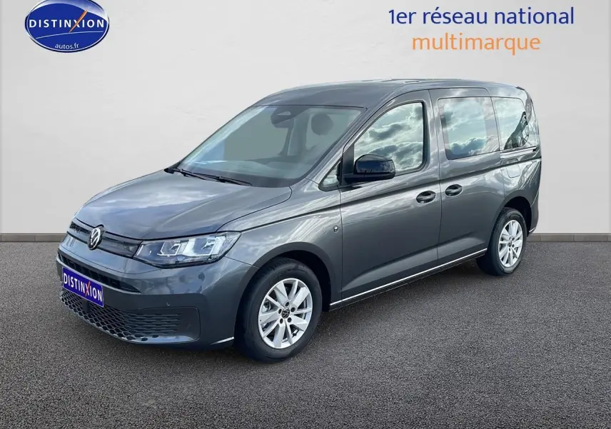 Volkswagen Caddy gris indien en vue 3/4 avant droit, avec vitres teintées et jantes alliage.