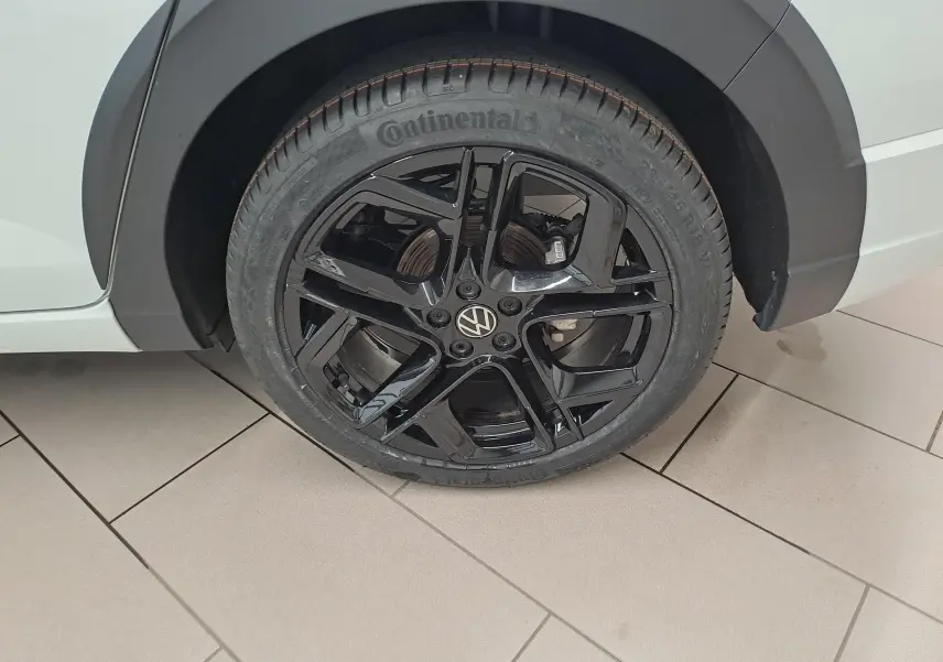 Gros plan sur la jante noire en alliage léger 18'' York du Volkswagen Taigo blanc pur, côté arrière droit.