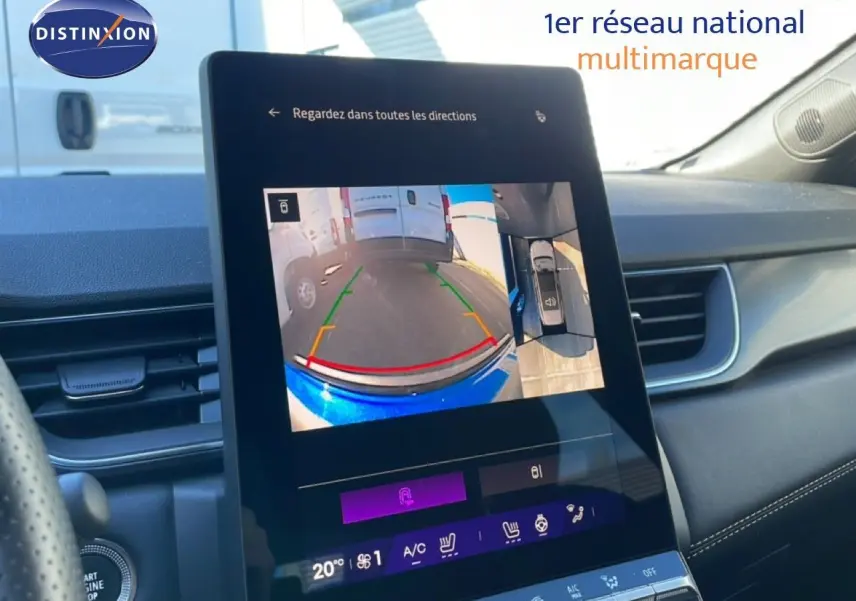 Vue intérieure du tableau de bord de la Renault Symbioz bleu iron metal, écran tactile affichant la caméra de recul et l’aide au stationnement.