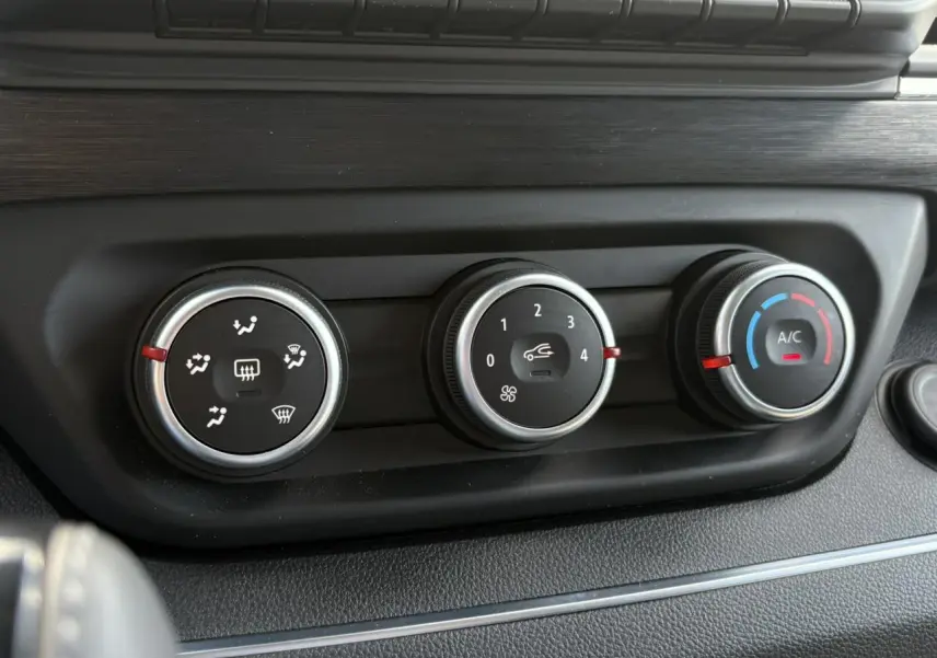 Gros plan sur les commandes de climatisation du Renault Trafic Fourgon 2024, finition Urban Grey, intérieur noir.