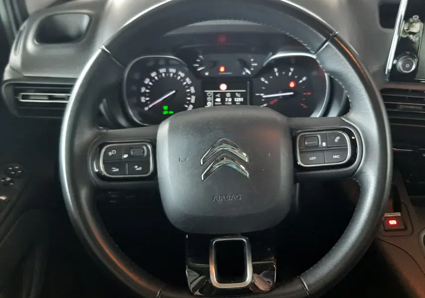 Vue rapprochée du volant noir du Citroën Berlingo 2019 avec commandes intégrées et tableau de bord visible.