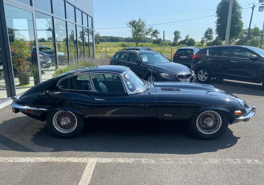 Profil côté gauche d'une Jaguar S-Type Type E Coupé 4.2 Série 2 noire de 1970 avec jantes à rayons classiques.
