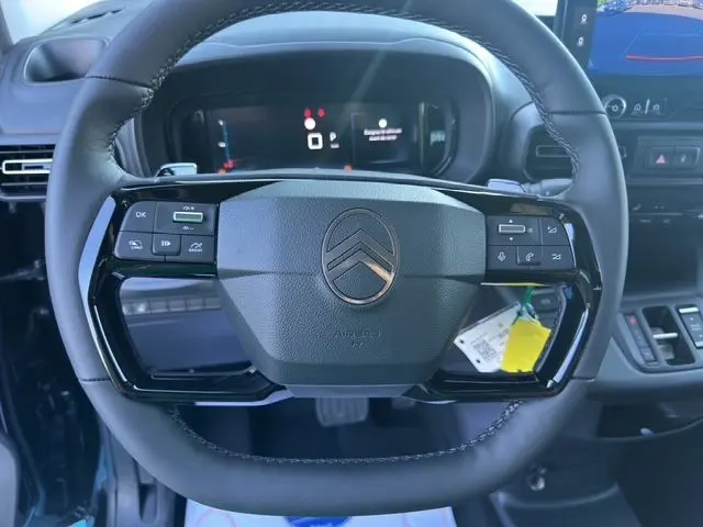 Volant noir du Citroën Berlingo 2025 N1 BlueHDi 130 avec commandes intégrées et tableau de bord numérique visible.