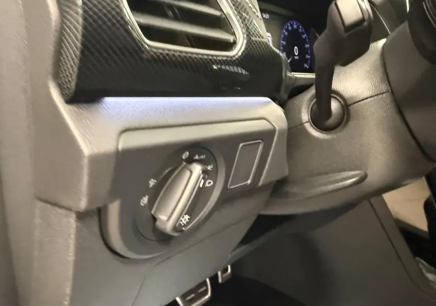 Gros plan sur le tableau de bord côté gauche du Volkswagen T-Cross 1.5 TSI 150 DSG7 R-Line, finition noire avec détails carbone.