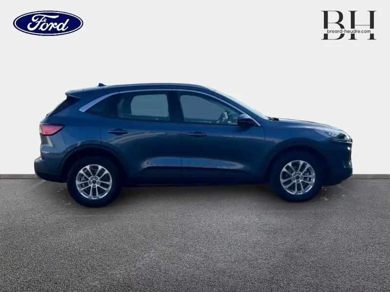 Vue latérale droite d'un Ford Kuga 2023 bleu azur métallisé avec jantes alliage et lignes épurées.