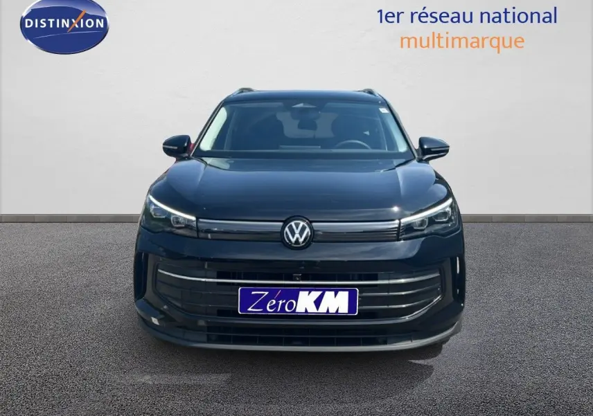 Vue frontale du Volkswagen Tiguan noir Grenadilla métal avec calandre épurée et phares LED fins allumés.
