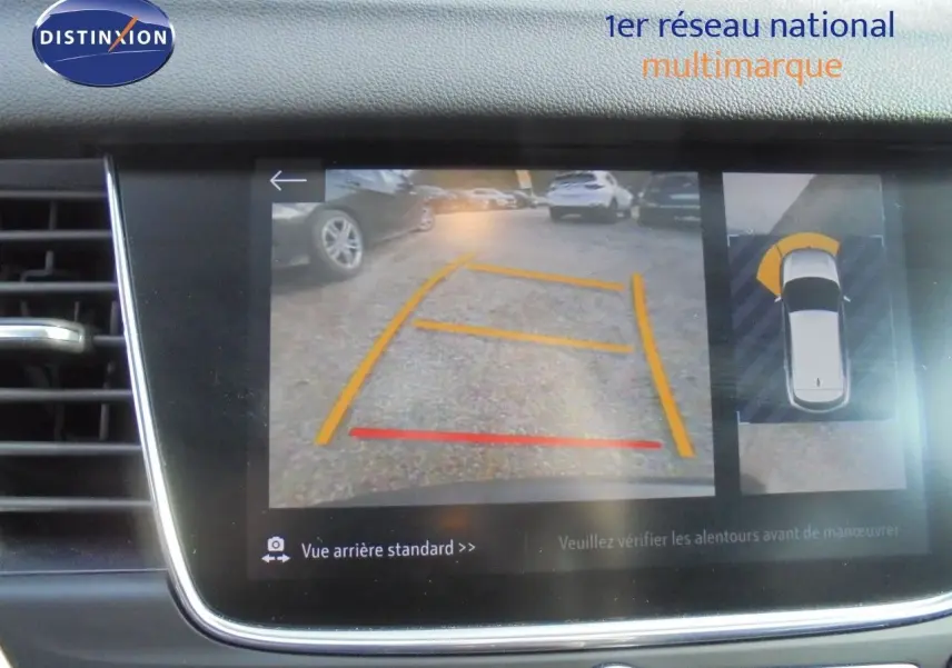 Écran multimédia montrant la caméra de recul avec guidage de trajectoire du SUV Opel Grandland X gris Moai Metal.