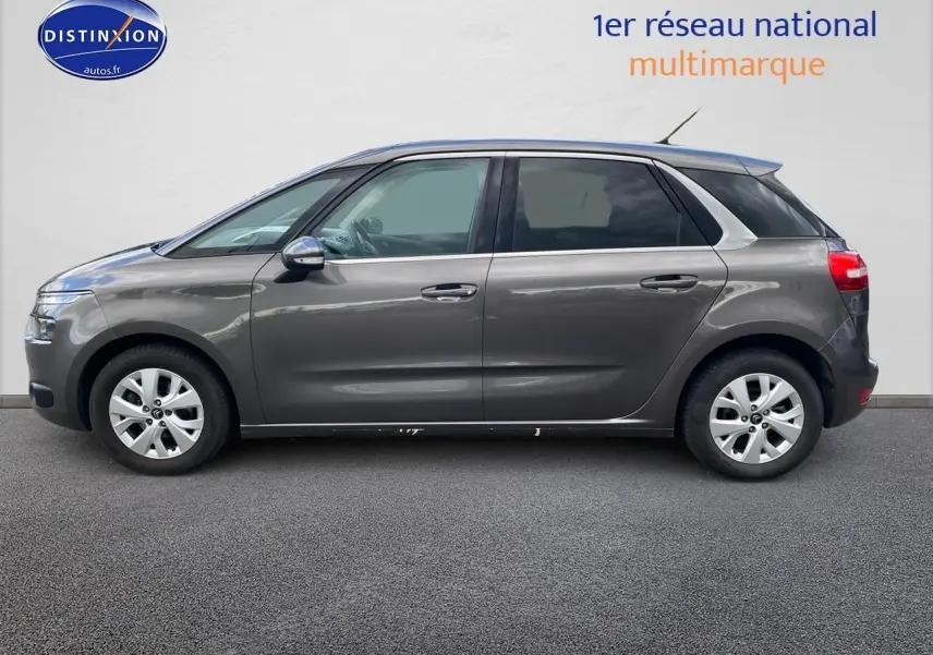 Profil côté gauche d'un Citroën C4 Picasso gris 2016, avec vitres teintées et jantes alliage visibles.