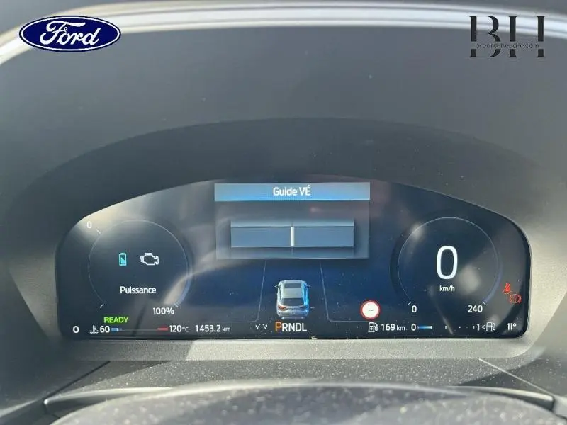 Vue rapprochée du tableau de bord numérique du Ford Kuga 2026 affichant la vitesse à 0 km/h et l'indicateur de puissance hybride.