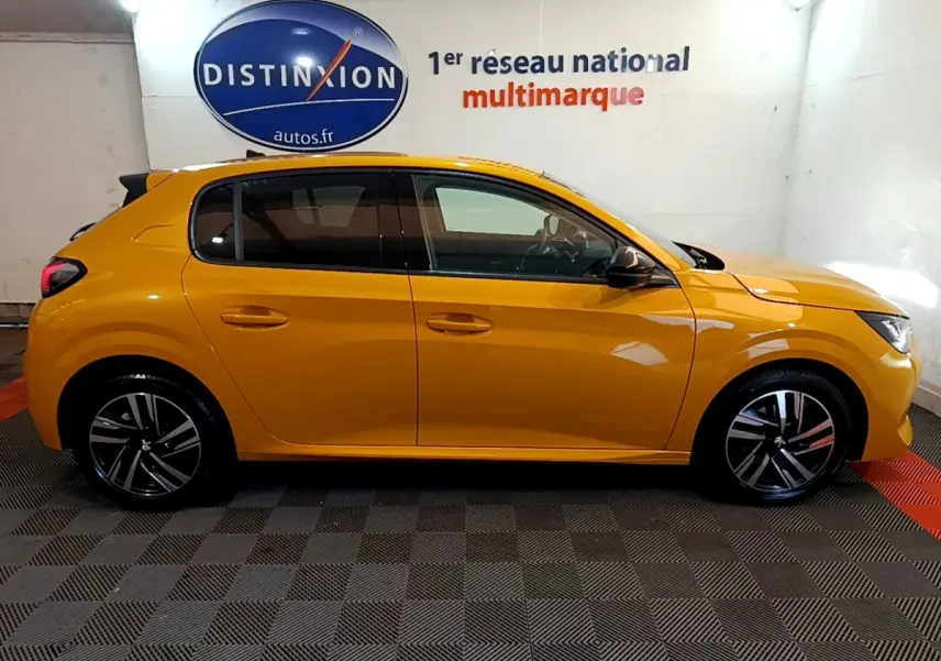 Profil droit d'une Peugeot 208 jaune 2023 dans un showroom avec jantes alliage et vitres teintées.