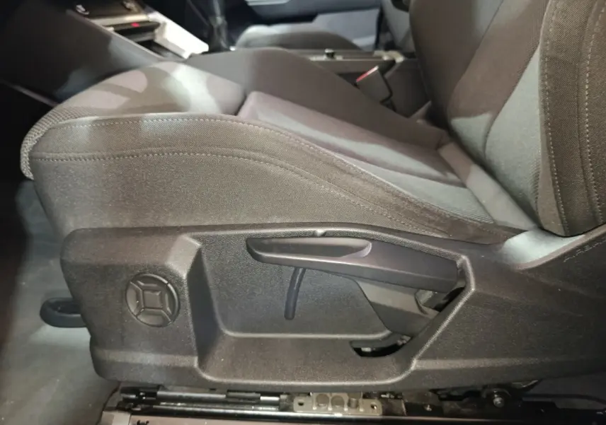 Détail du siège avant droit gris foncé de l'Audi Q3 Sportback 45 TFSI e avec réglage manuel, vue latérale intérieure.