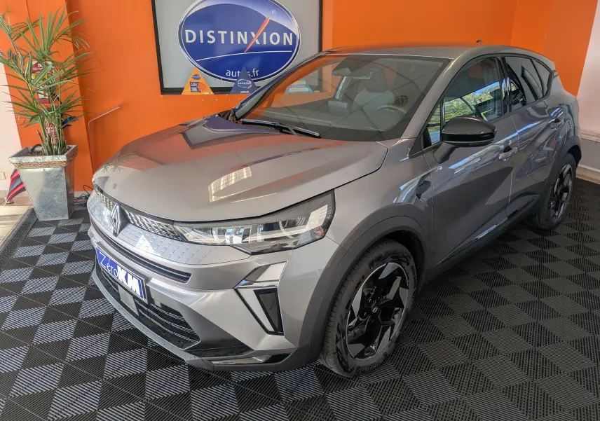 Renault Captur E-Tech gris cassiopée en 3/4 avant droit avec jantes noires et rétroviseurs brillants noirs.