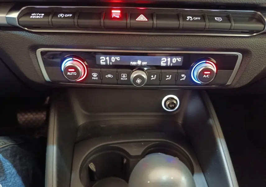 Vue rapprochée du tableau de bord et de la console centrale noire de l’Audi A3 35 TDI, montrant la climatisation digitale et les commandes.