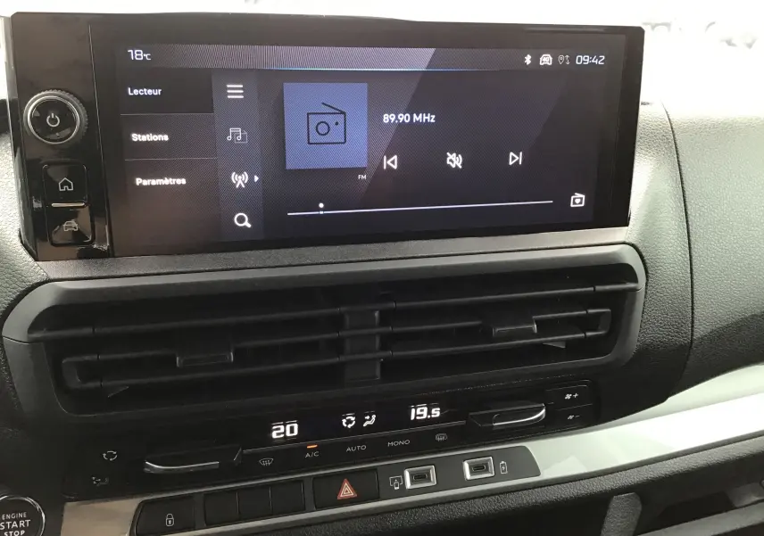 Vue rapprochée de l’écran tactile et de la console centrale du Peugeot Expert XL gris titane avec commandes climatisation et démarrage sans clé.