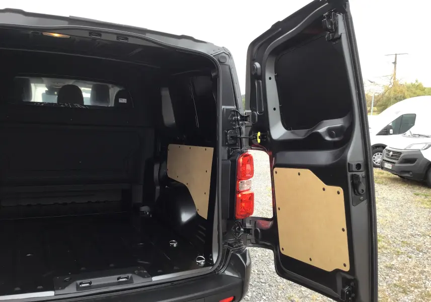Vue arrière ouverte du Peugeot Expert Cabine Approfondie gris titane, montrant l’espace de chargement avec panneaux de protection en bois.