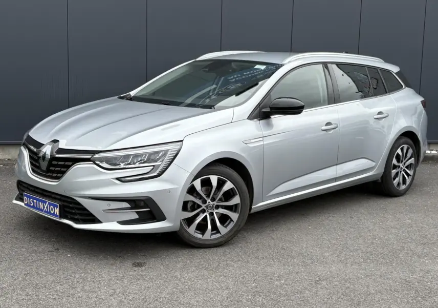 Renault Mégane Break gris Highland vue 3/4 avant droit, avec jantes alliage et rétroviseurs noirs.