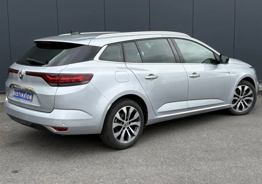 Renault Mégane Break Gris Highland vue 3/4 arrière droit, feux arrière LED et jantes alliage visibles.