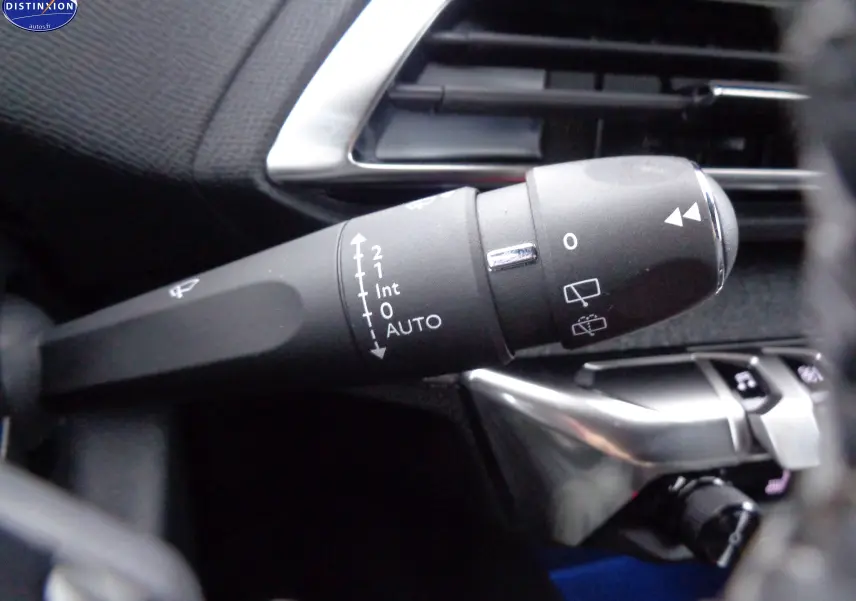 Gros plan sur la commande d'essuie-glace du côté gauche du tableau de bord d'un Peugeot 3008 noir métal 2023.