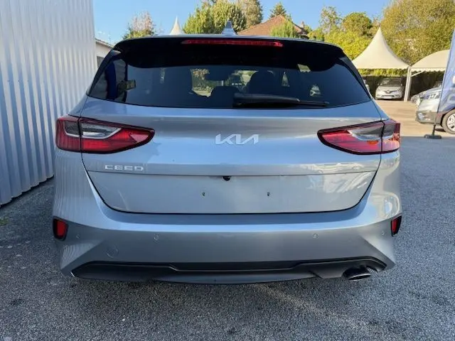 Vue arrière d'une KIA CEE'D 2024 argent lunaire avec feux LED et sortie d'échappement visible côté droit.