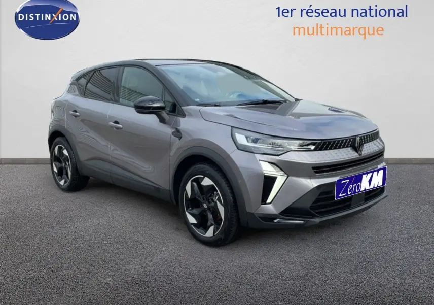 Renault Captur E-Tech F.Hybrid 2025 gris cassiopée métal, vue 3/4 avant avec toit noir et jantes bicolores.