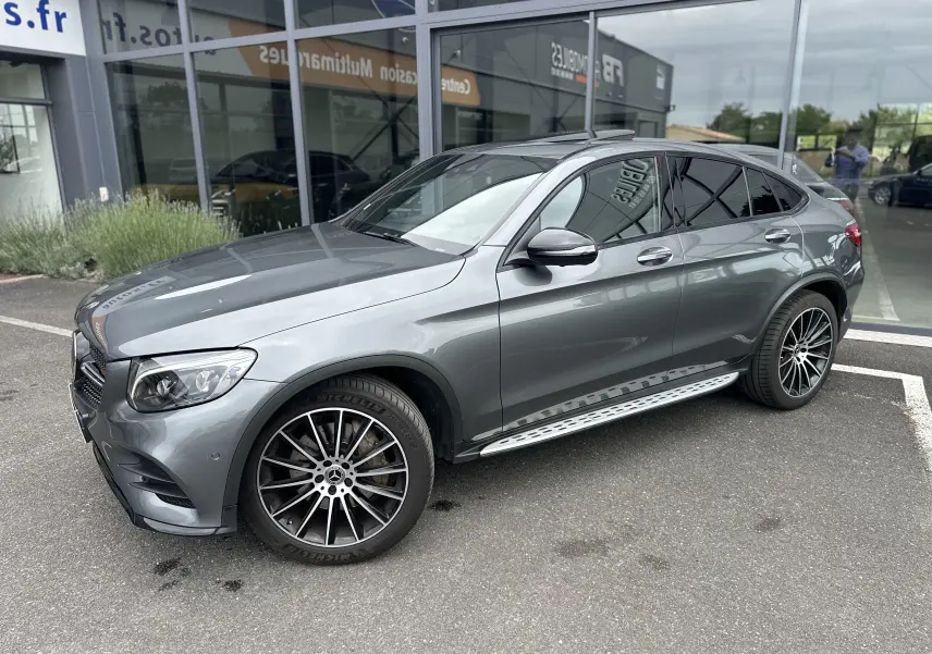 Mercedes GLC Coupé 250 D gris foncé vu de côté gauche 3/4 avant, avec jantes alliage et marchepieds métalliques.
