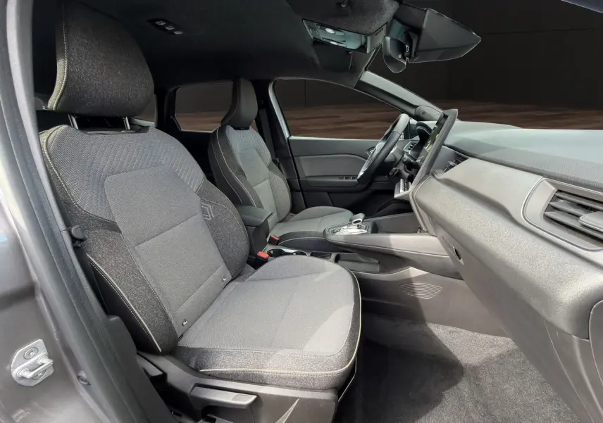 Vue intérieure côté droit de la Renault Symbioz gris clair, montrant les sièges avant et le tableau de bord moderne.