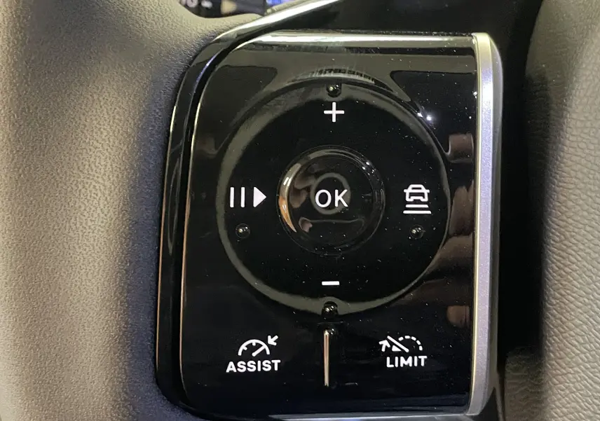 Gros plan sur les commandes au volant du Citroën C5 Aircross hybride 2026, boutons noirs avec fonctions d'assistance et limitation.