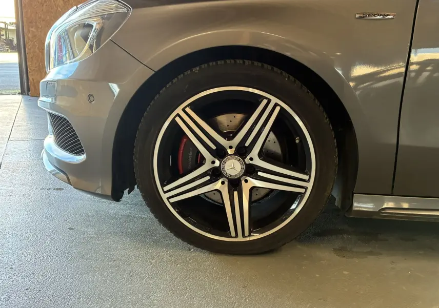 Gros plan sur la roue avant gauche gris métallisé d'une Mercedes Classe A 250 AMG Sport avec jante AMG cinq branches.