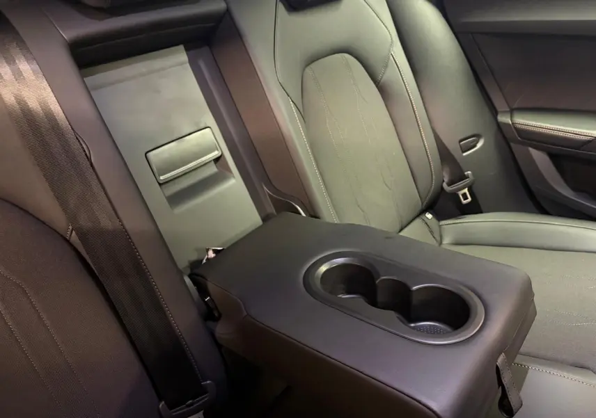Accoudoir central arrière avec porte-gobelets dans l'habitacle sombre d'un CUPRA Formentor 2025.