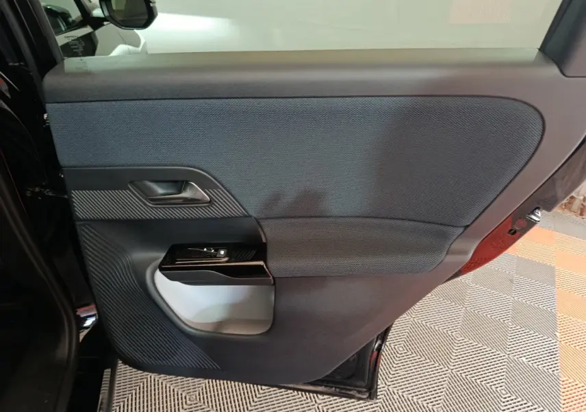 Porte arrière gauche noire de Citroën C5 Hybride 2026 avec habillage textile et commandes de fenêtre intégrées.