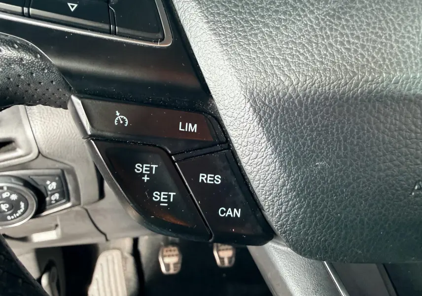 Vue intérieure arrière côté droit de la Ford Focus 1.5 TDCI 120 ST Line grise, sièges tissu noir avec surpiqûres rouges.