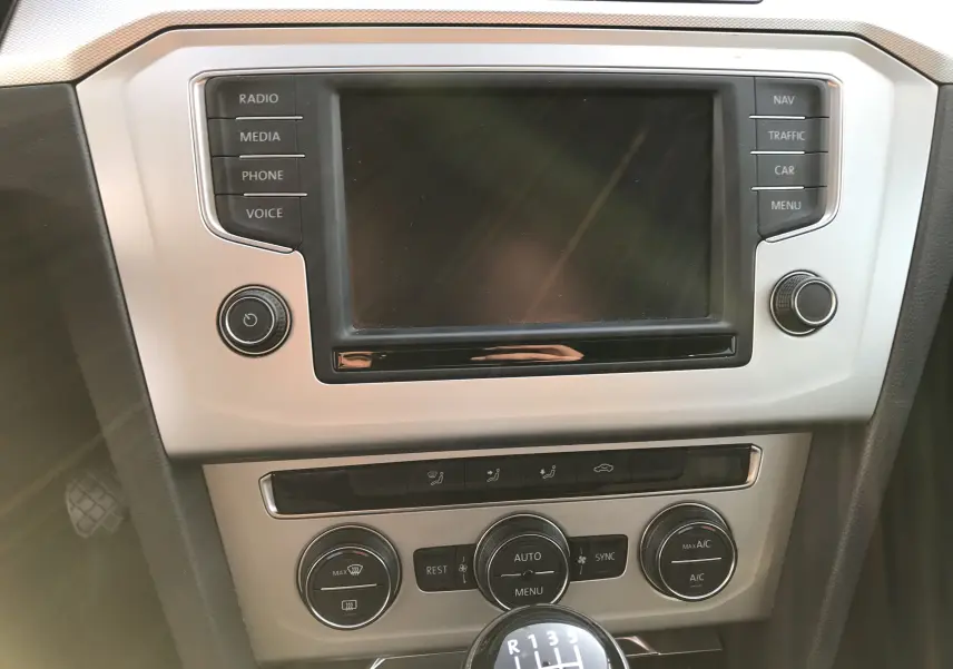 Tableau de bord argenté de Volkswagen Passat 2015 avec écran tactile et levier de vitesses manuel en gros plan.