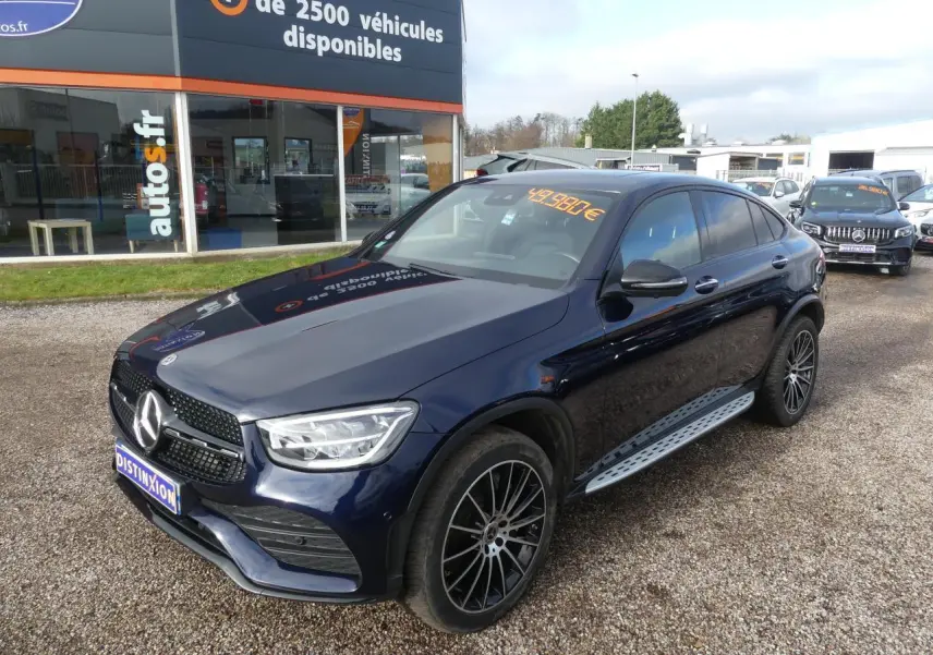 Mercedes GLC Coupé 300 hybride bleu foncé en 3/4 avant droit avec jantes AMG et marchepieds acier.