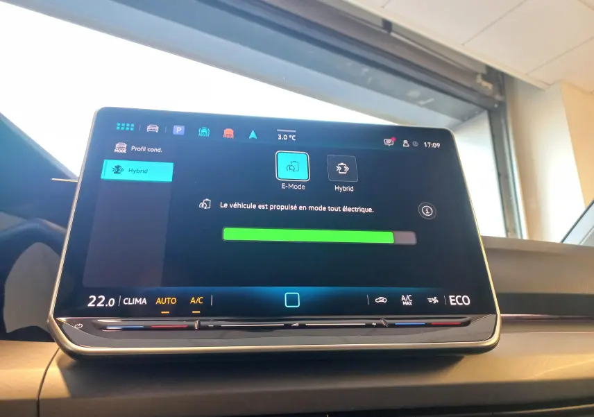 Écran tactile central de la Volkswagen Golf 1.5 eHybrid 2025 affichant le mode tout électrique en intérieur.