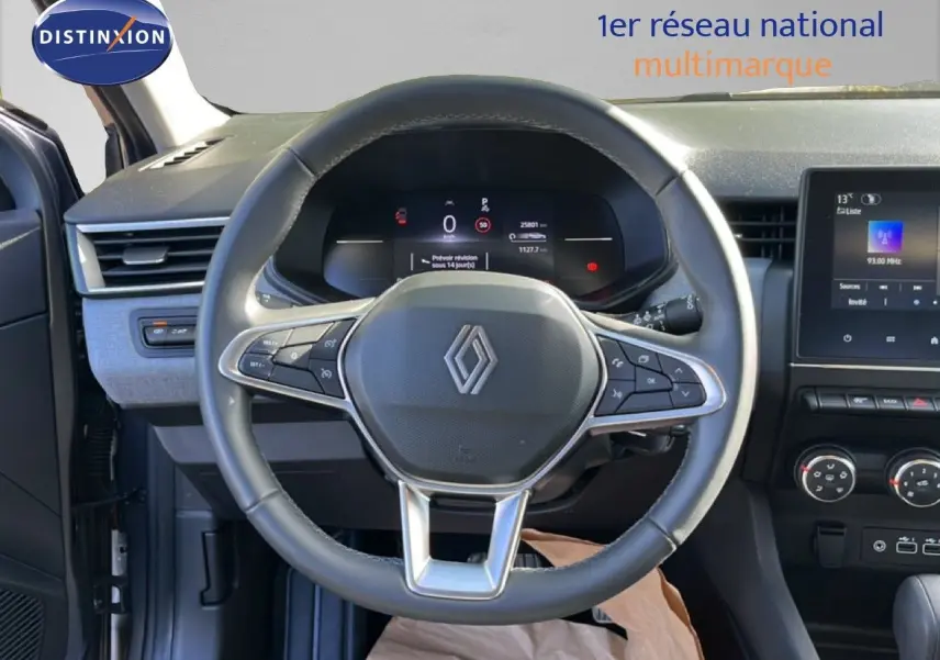 Vue intérieure centrée sur le volant multifonction de la Renault Clio 2025 avec tableau de bord numérique et console centrale.