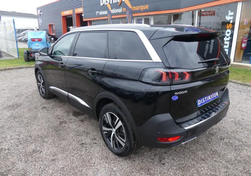 Peugeot 5008 GT noir métallisé vue 3/4 arrière droit avec jantes bi-ton et vitres surteintées.